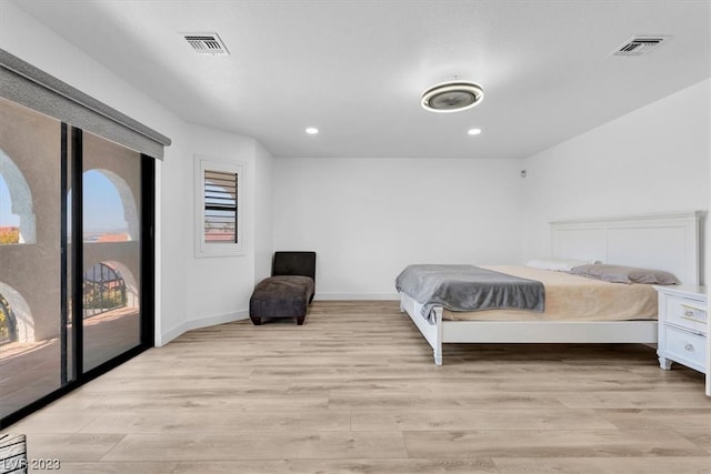 bedroom featuring light hardwood / wood-style flooring and access to outside