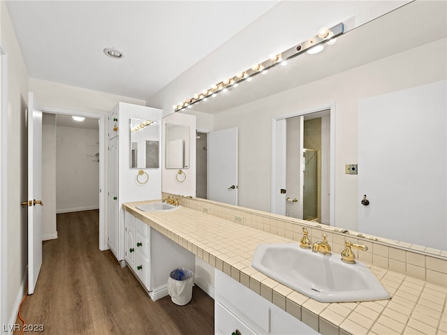 bathroom featuring hardwood / wood-style floors and dual bowl vanity