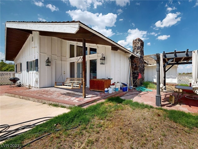 back of property with a patio and a pergola