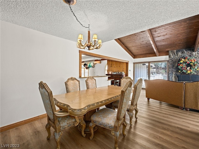 dining area with a chandelier, wooden ceiling, dark wood-type flooring, a textured ceiling, and vaulted ceiling with beams