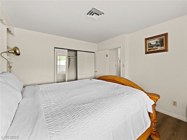 bedroom with dark hardwood / wood-style floors and a closet