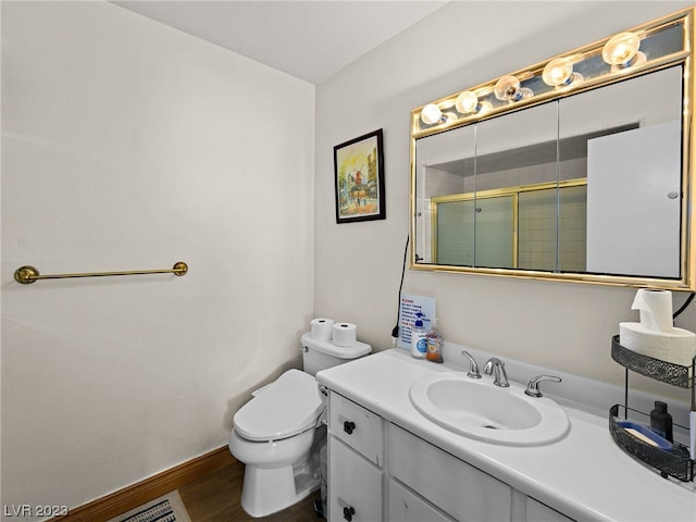 bathroom with toilet, oversized vanity, and hardwood / wood-style flooring