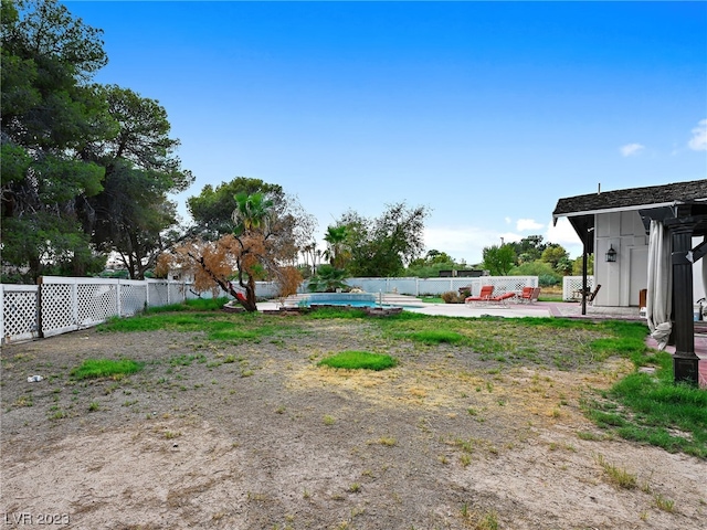 view of yard featuring a patio area and a fenced in pool