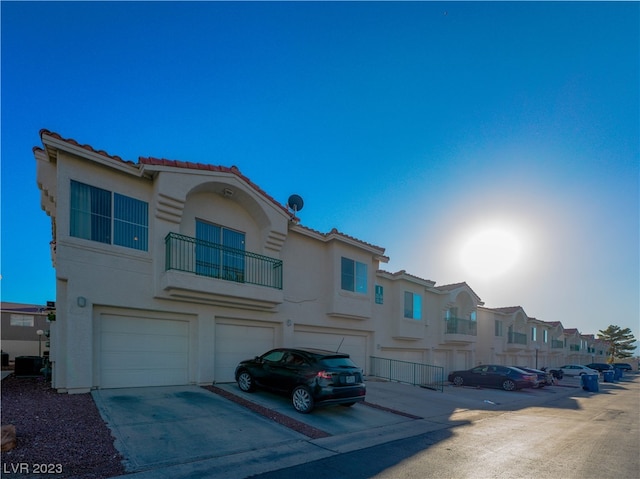 view of front of property with a balcony and a garage