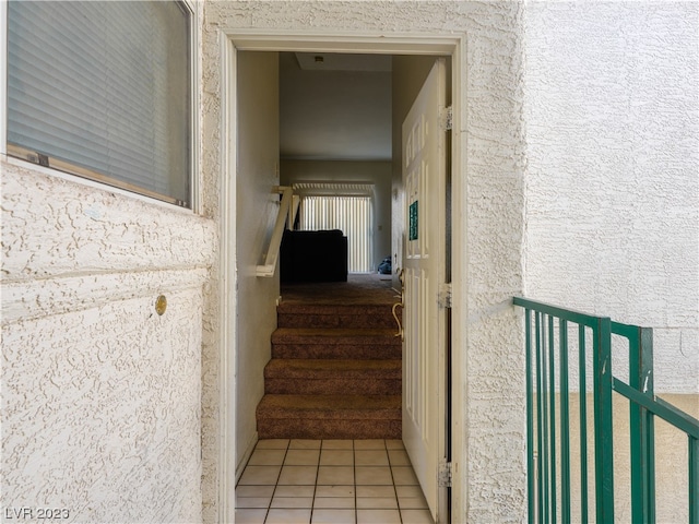 stairs with light tile floors