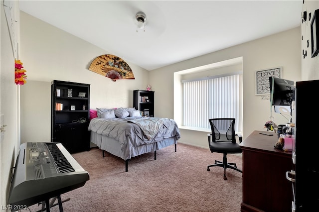 bedroom featuring light carpet and vaulted ceiling