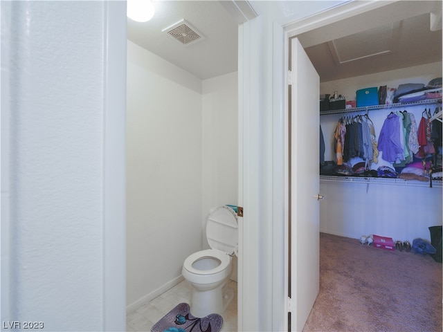 bathroom with toilet and tile flooring