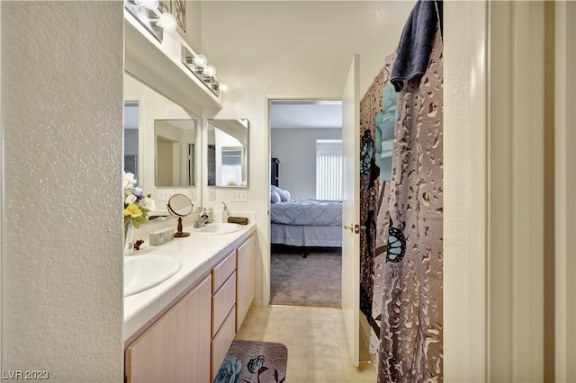 bathroom with tile flooring and dual vanity