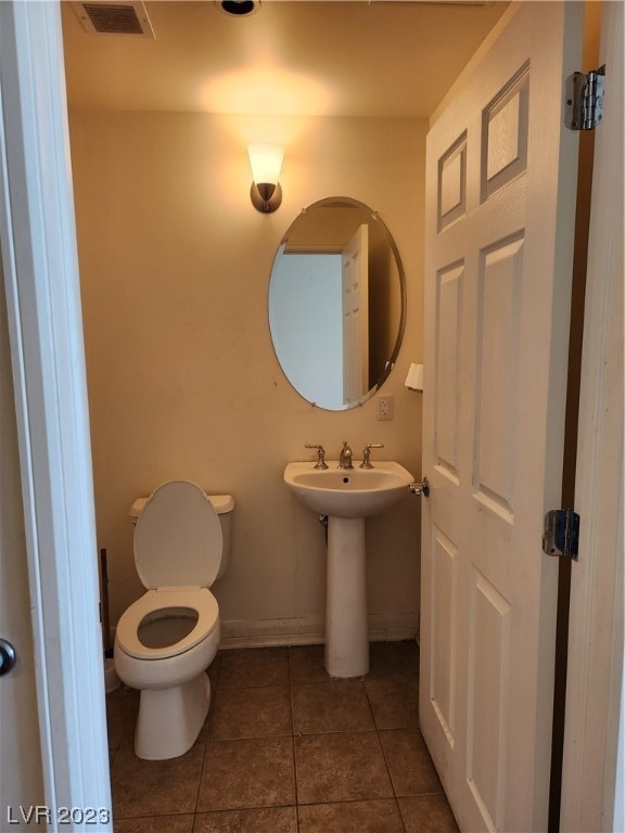 bathroom with tile floors and toilet