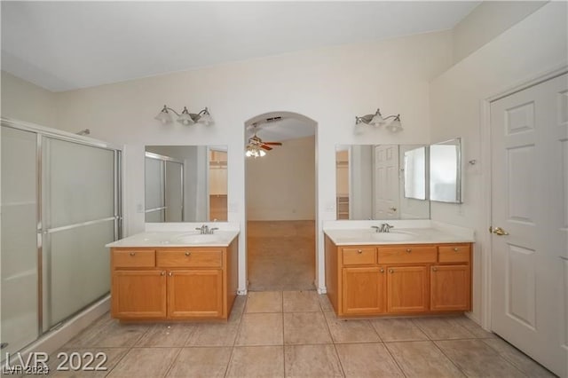 bathroom with ceiling fan, oversized vanity, dual sinks, and tile floors