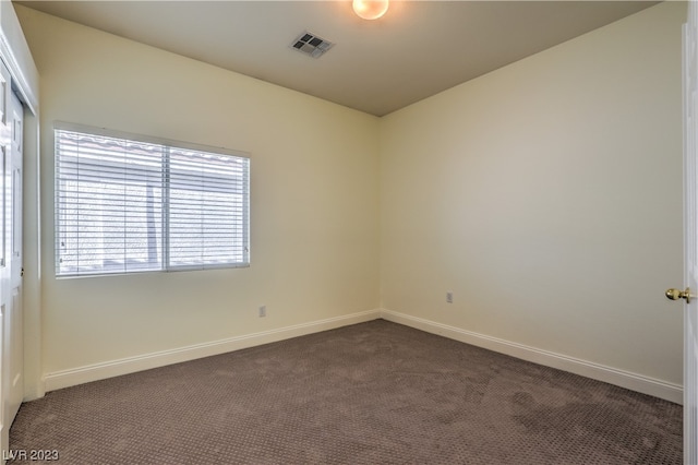 carpeted spare room featuring a wealth of natural light