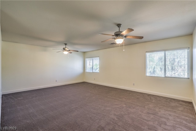 carpeted empty room featuring ceiling fan