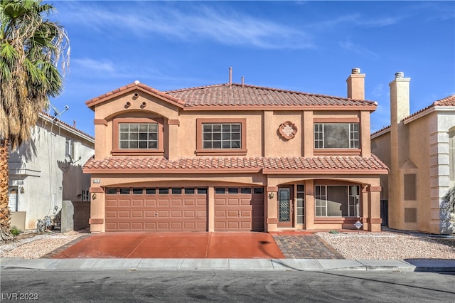 mediterranean / spanish-style home featuring a garage