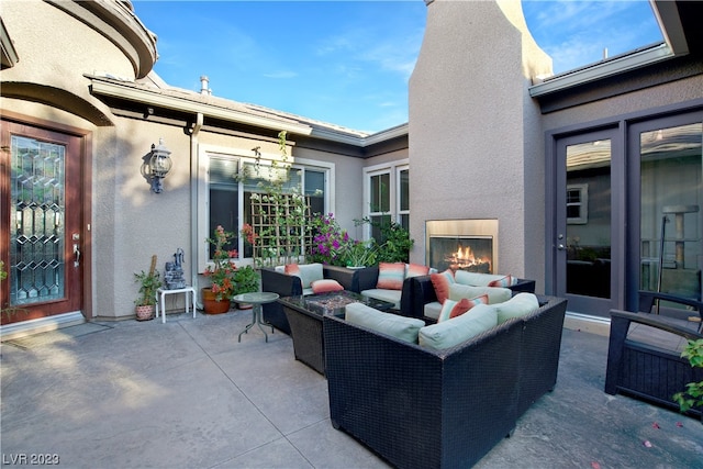 view of patio / terrace featuring an outdoor living space with a fireplace