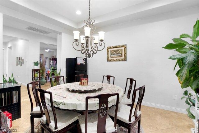 tiled dining room with a notable chandelier