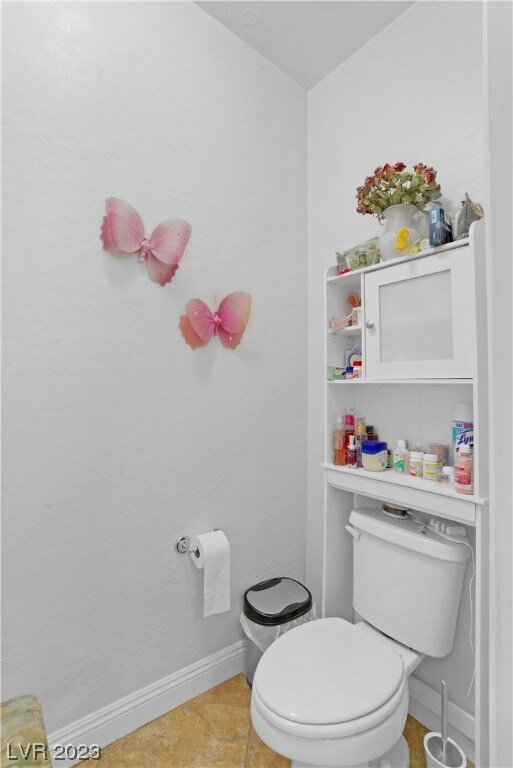 bathroom featuring toilet and tile flooring