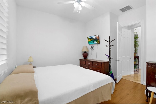 bedroom with ceiling fan and light hardwood / wood-style floors