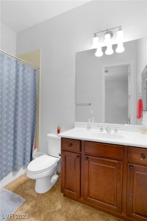 bathroom with vanity, tile flooring, and toilet