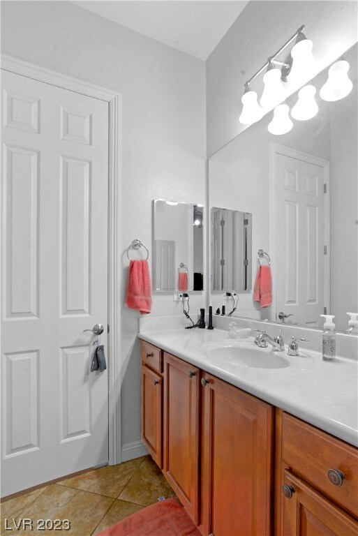 bathroom featuring tile floors and vanity