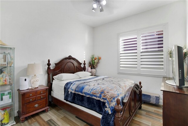 bedroom with ceiling fan and hardwood / wood-style flooring