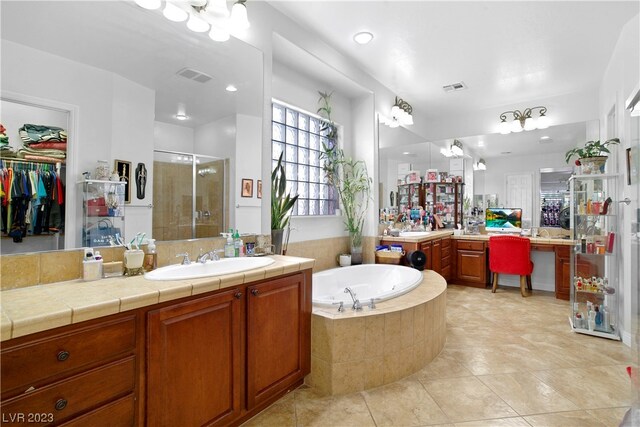 bathroom with shower with separate bathtub, dual bowl vanity, and tile flooring