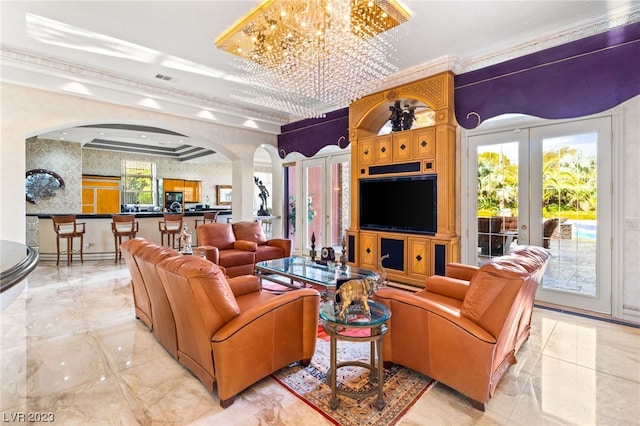 living room featuring french doors, crown molding, and an inviting chandelier