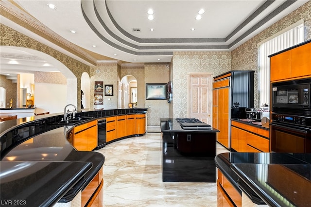 kitchen with a raised ceiling, sink, ornamental molding, wall oven, and black microwave