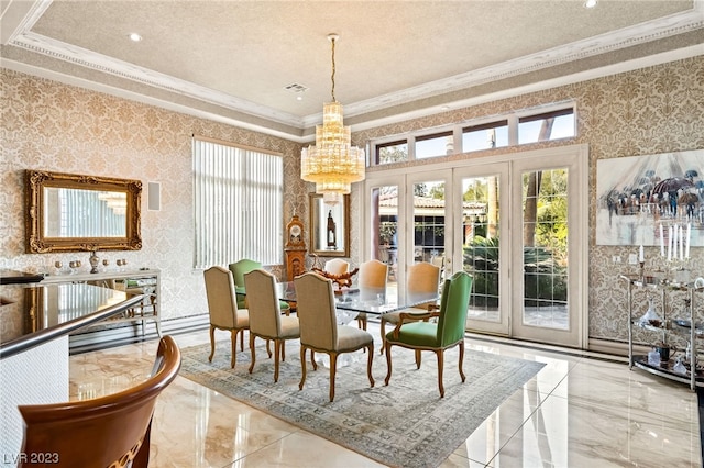 dining room featuring a raised ceiling, french doors, crown molding, and an inviting chandelier