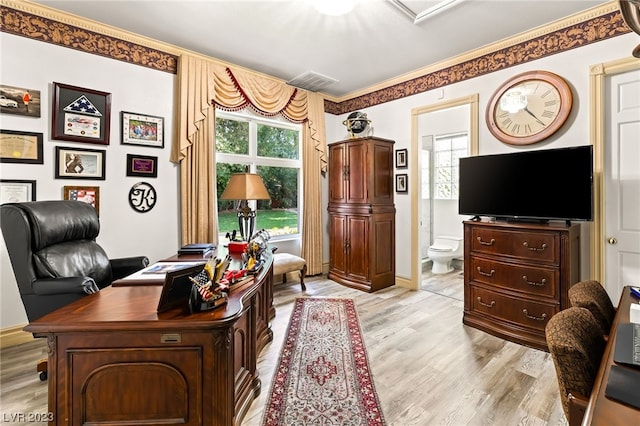 office featuring crown molding, a healthy amount of sunlight, and light wood-type flooring