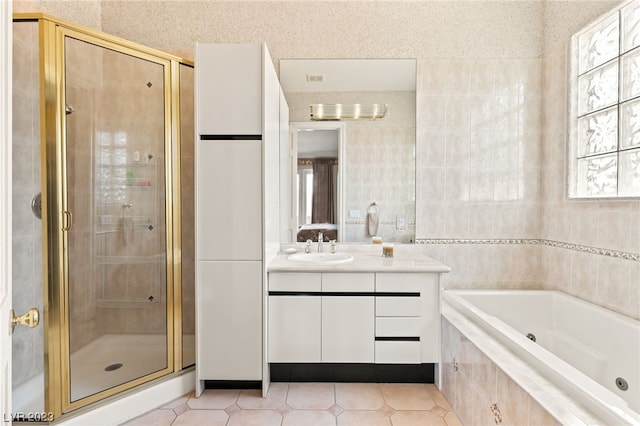 bathroom featuring tile patterned floors, vanity, and plus walk in shower