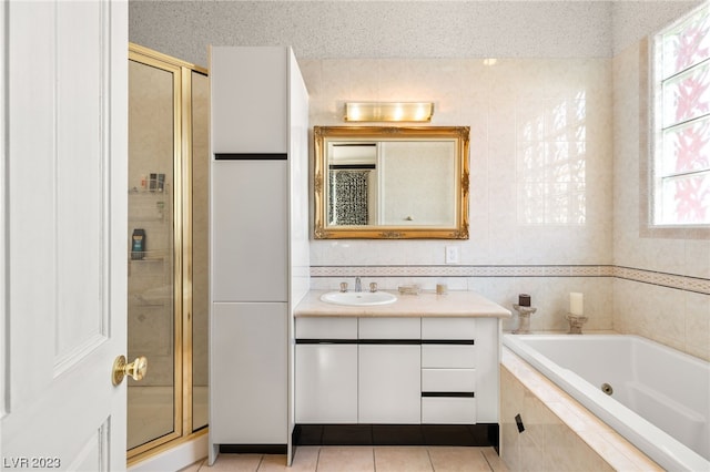 bathroom featuring tile patterned floors, vanity, plus walk in shower, and a textured ceiling