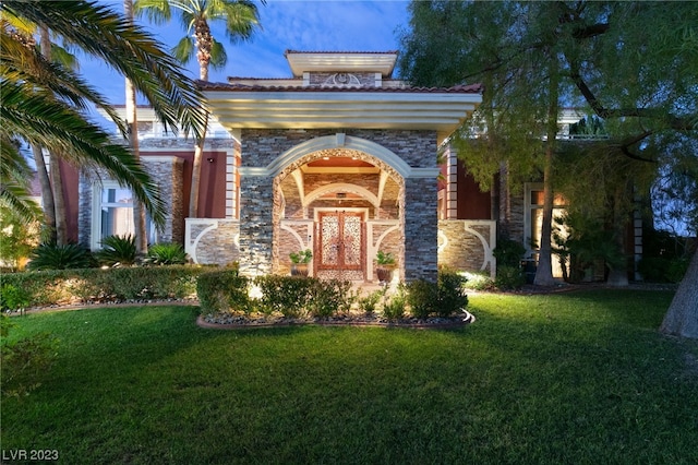 doorway to property featuring a yard