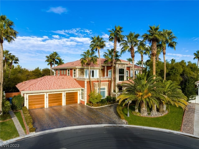 view of front of property featuring a balcony and a garage