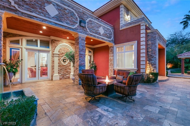 view of patio / terrace featuring french doors and a fire pit