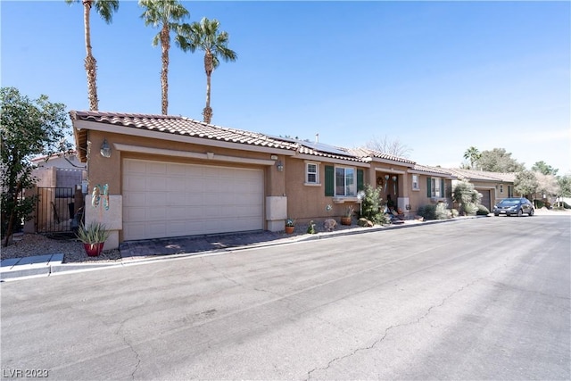 view of front of home with a garage and solar panels