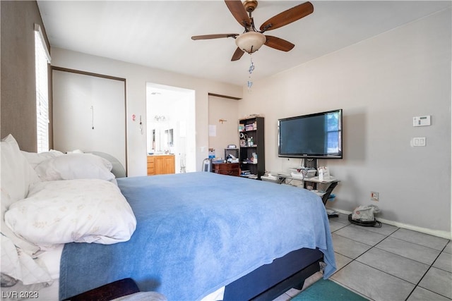 tiled bedroom with ceiling fan and connected bathroom