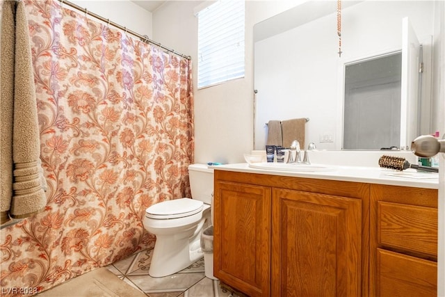 bathroom with tile patterned floors, vanity, and toilet