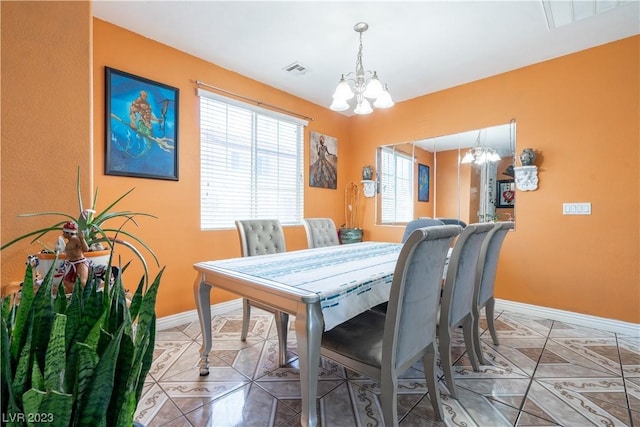 dining space featuring a chandelier and tile patterned flooring