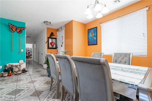 tiled dining space with a notable chandelier