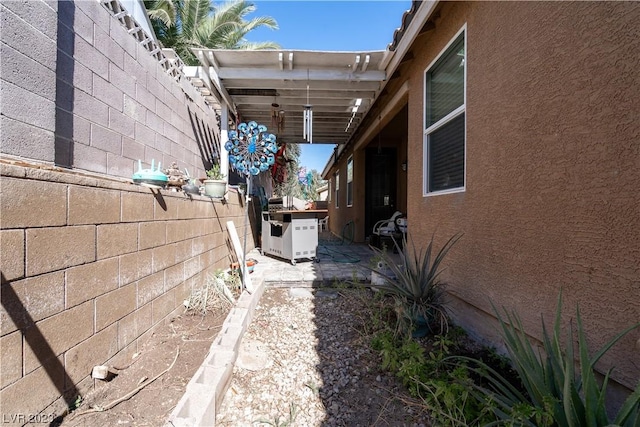 view of side of home with a pergola and a patio area