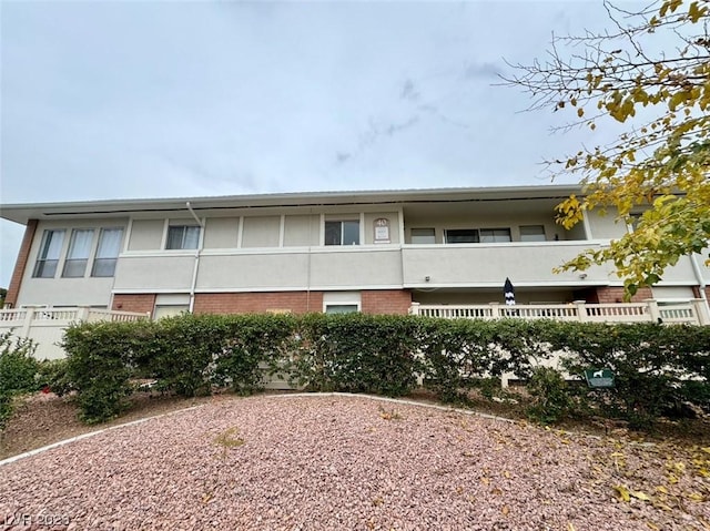 exterior space with brick siding and stucco siding