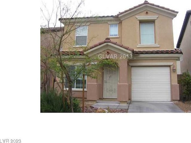 mediterranean / spanish house featuring a garage