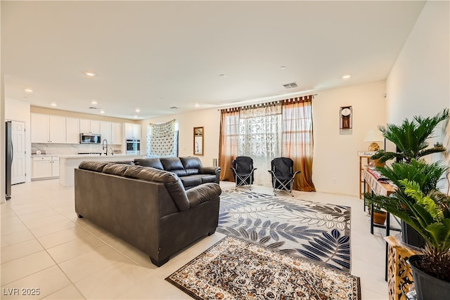 living area with recessed lighting, visible vents, and light tile patterned floors