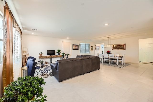 living room featuring visible vents and recessed lighting