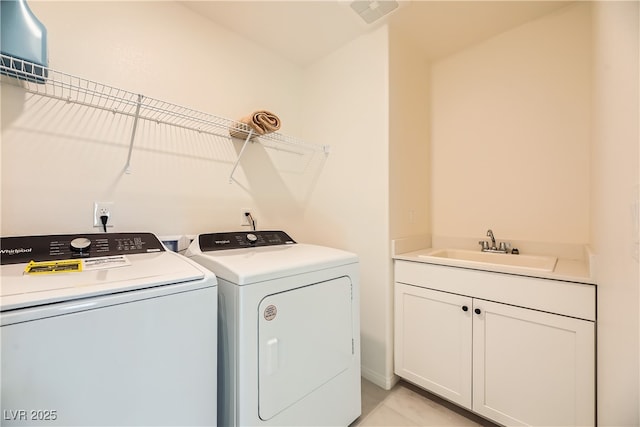 laundry area featuring visible vents, cabinet space, a sink, and washer and clothes dryer