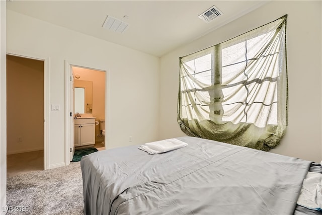 carpeted bedroom featuring lofted ceiling, baseboards, visible vents, and ensuite bath