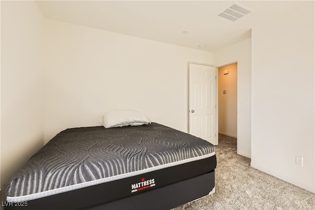 bedroom featuring light colored carpet, visible vents, and baseboards