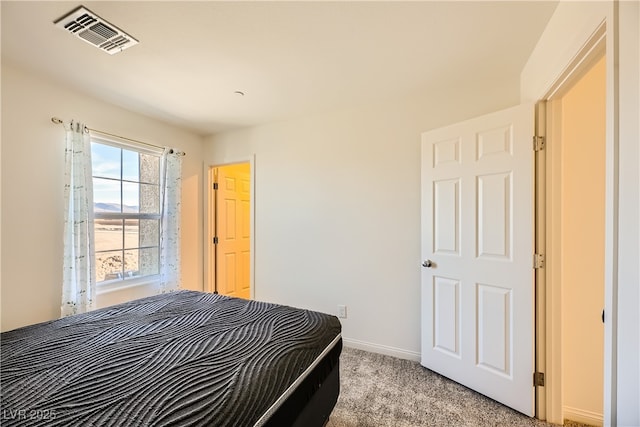 bedroom with light carpet, baseboards, and visible vents