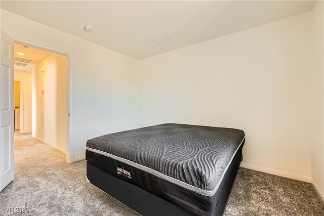 carpeted bedroom with visible vents and baseboards