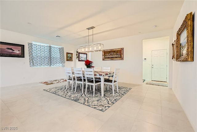 dining room featuring a chandelier, visible vents, and light tile patterned flooring